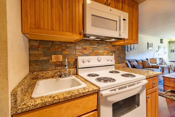 a kitchen with a stove and a sink