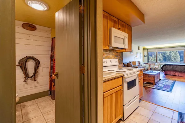 a kitchen with stainless steel appliances granite countertop a stove and a refrigerator