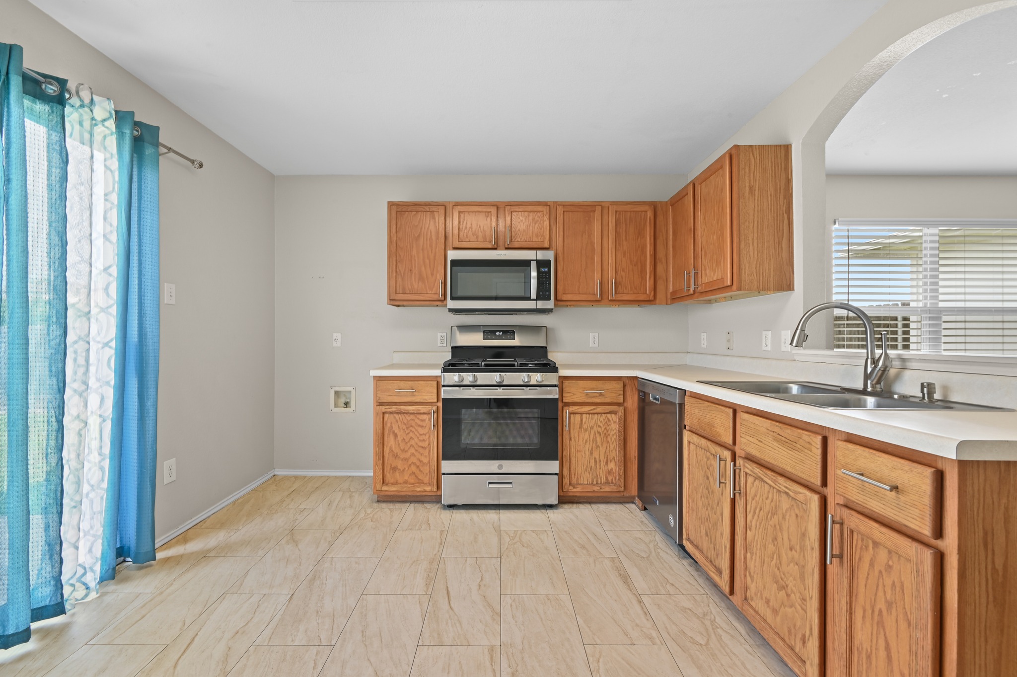 112 Mason Reed Cove Kyle, TX 78640 - Photo 10 of 26 a kitchen with granite countertop a stove cabinets and a sink