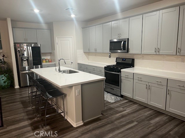 29901 Bridlegate Way Menifee, CA 92584 - Photo 10 of 43 a kitchen with a sink appliances and cabinets