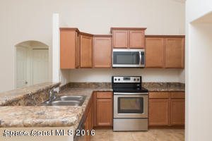 6150 Adina Road Cocoa, FL 32927 - Photo 2 of 13 a kitchen with a stove and a microwave