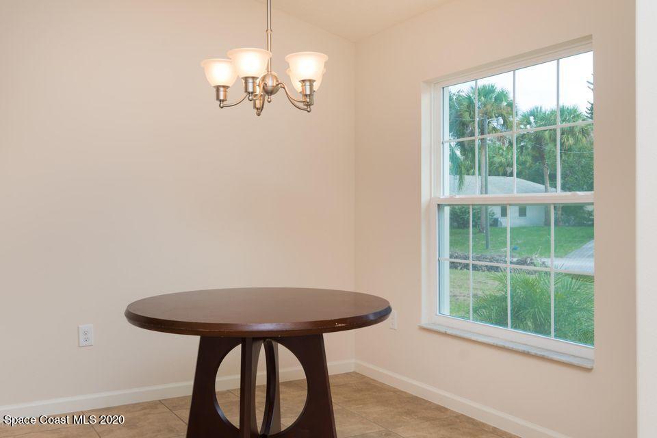6150 Adina Road Cocoa, FL 32927 - Photo 6 of 13 a view of a room with a table and chairs