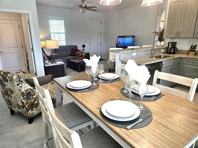 a dining room with furniture and a wooden floor