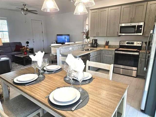 a kitchen with a table chairs stove and microwave