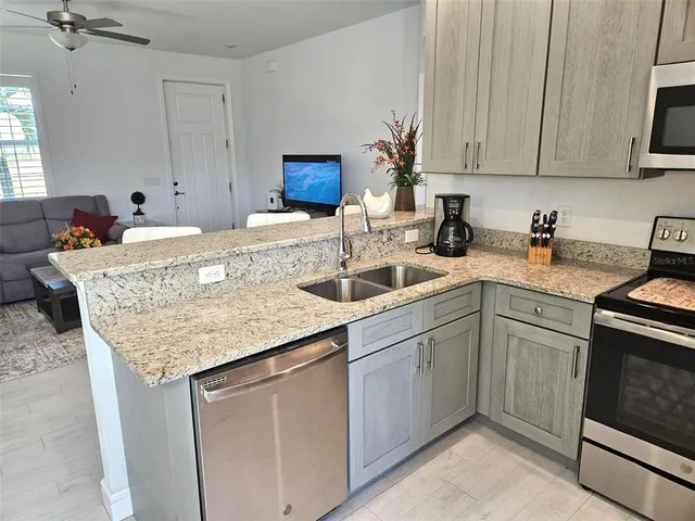 a kitchen with sink cabinets and microwave
