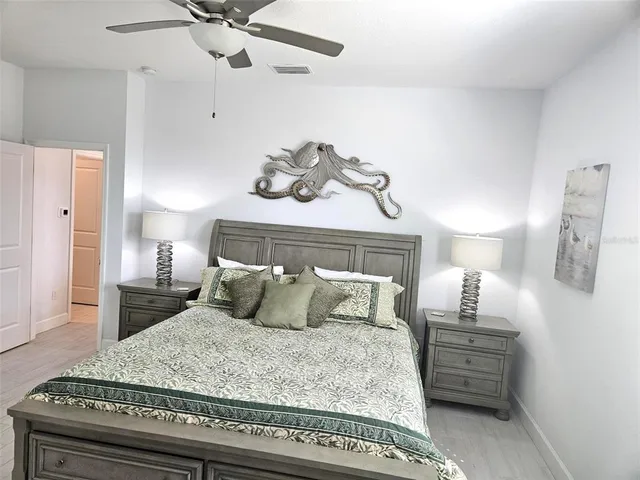 a bedroom with a bed and wooden floor