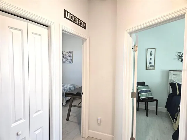 a view of a hallway with workspace and a couch