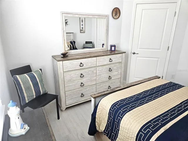 a bedroom with a bed and a mirror