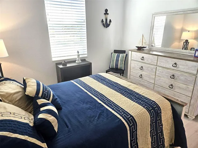 a bedroom with a bed and with furniture