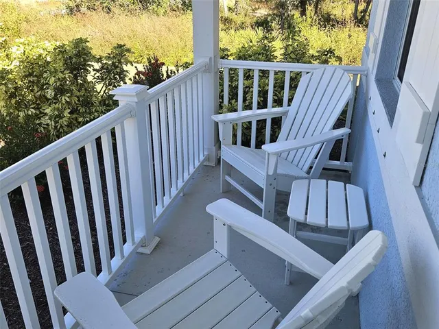 a view of deck with a large window and wooden floor