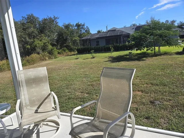 a view of a chairs and table in patio