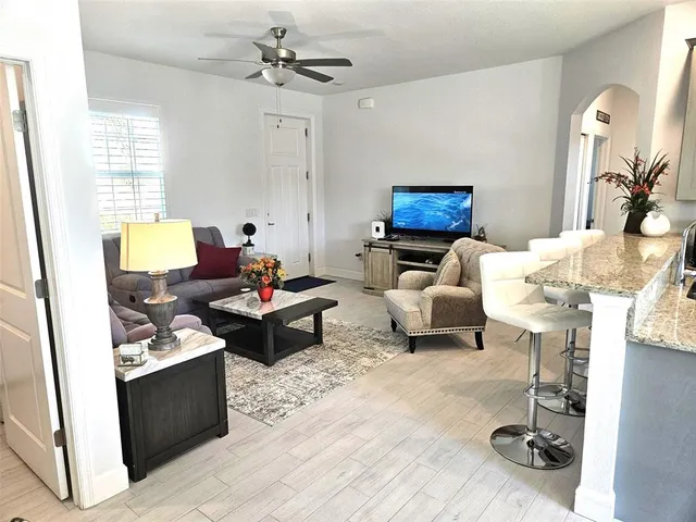 a living room with furniture and a mirror