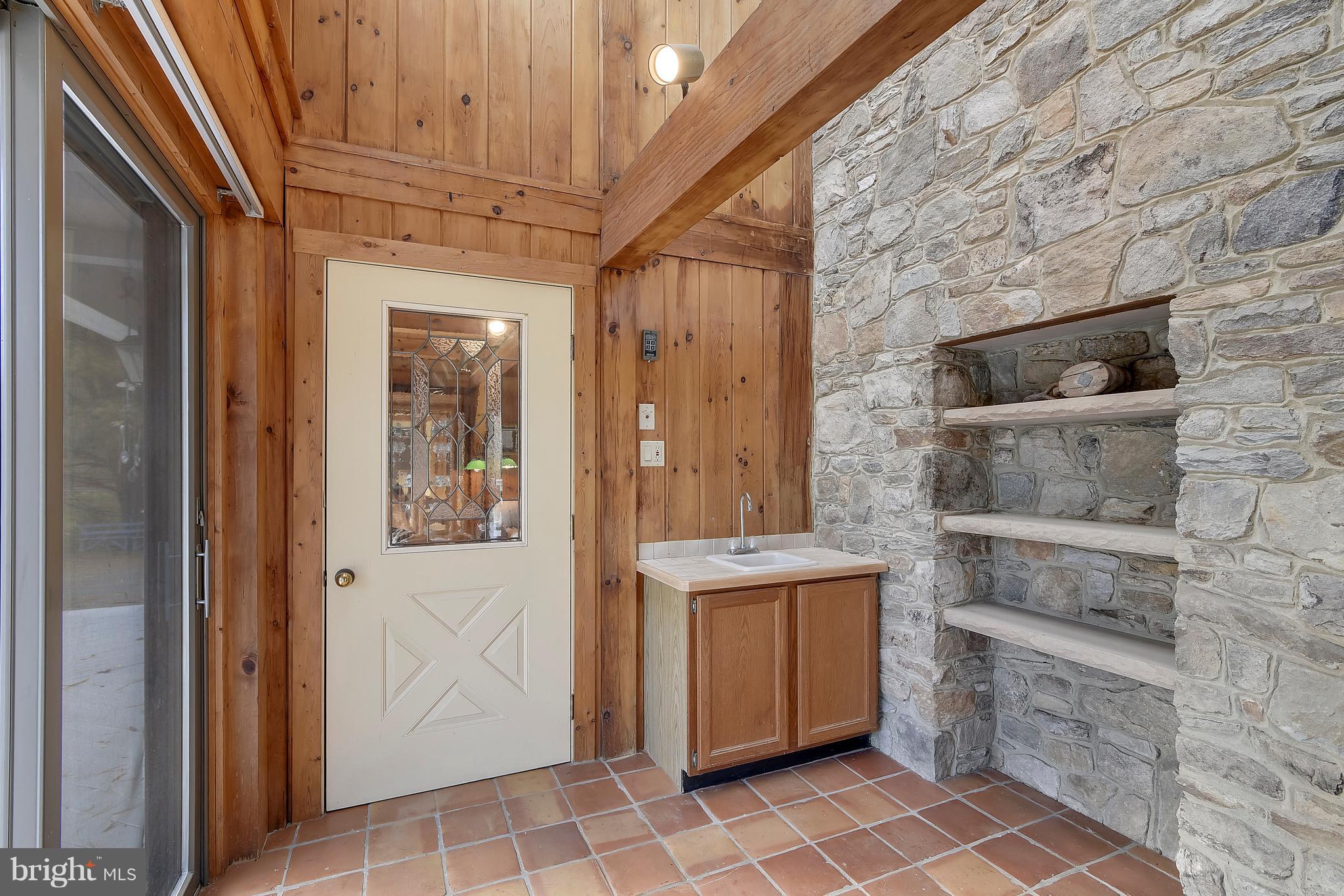 38243 Lime Kiln Road Middleburg, VA 20117 - Photo 27 of 94 Stone shelving and wet bar, door to living room