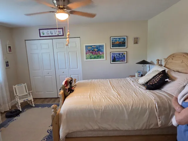 a bedroom with a bed and a chandelier