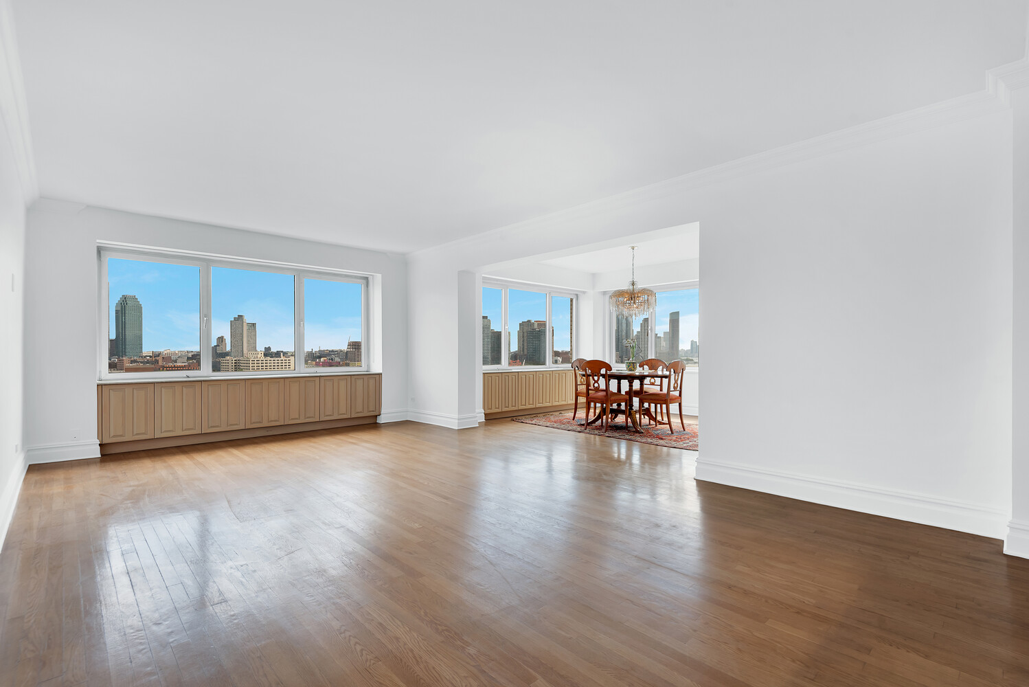 45 Sutton Place South, Unit 14F Manhattan, NY 10022 - Photo 2 of 20 a view of a livingroom with wooden floor and a cabinet