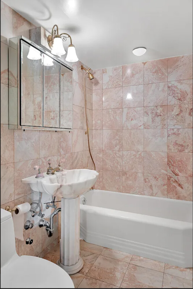 45 Sutton Place South, Unit 14F Manhattan, NY 10022 - Photo 7 of 20 a bathroom with a sink a toilet and bathtub