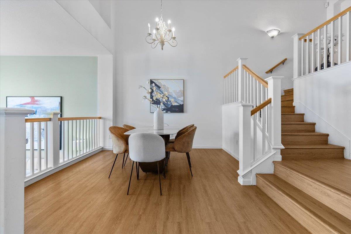 133 Cliff Swallow Court Brisbane, CA 94005 - Photo 10 of 39 a view of a dining room with furniture wooden floor and chandelier
