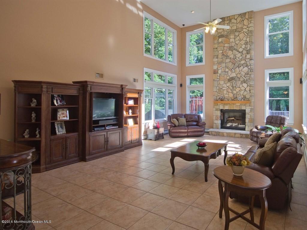 6 Applegate Road Millstone Township, NJ 08510 - Photo 8 of 40 a living room with fireplace furniture and a flat screen tv
