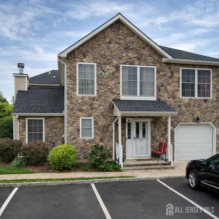 front view of a house with a car parked front of it