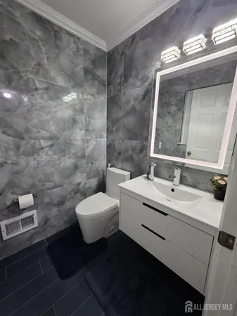 a bathroom with a toilet sink and mirror