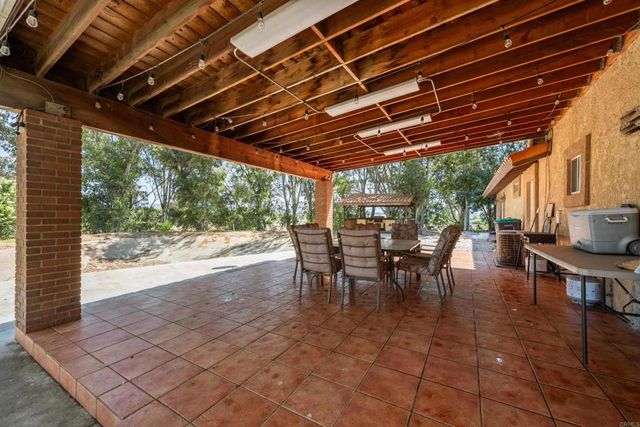 a view of a porch with furniture and a yard