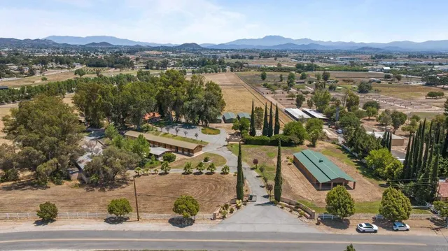 an aerial view of residential house with outdoor space and lake view