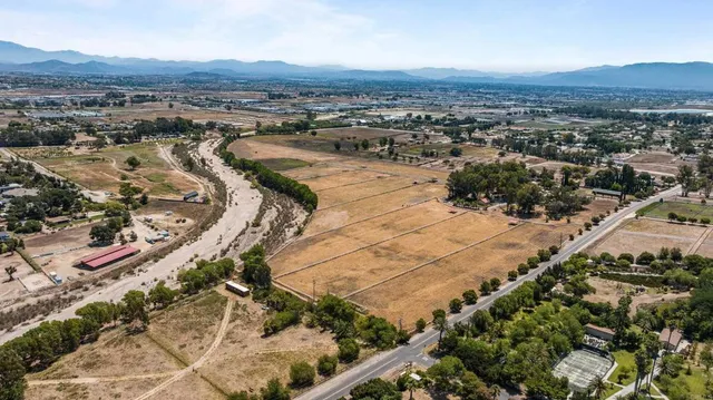 an aerial view of residential house and sandy dunes