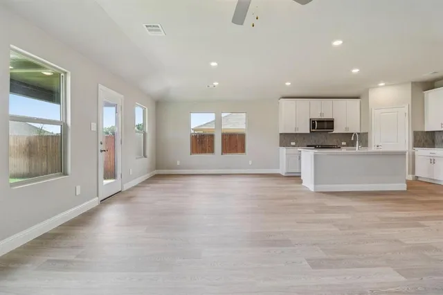 a view of kitchen with microwave and refrigerator