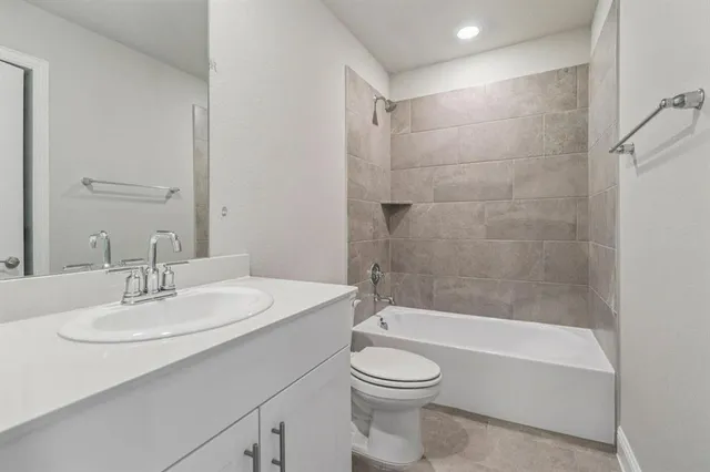 a bathroom with a bathtub a sink a toilet and a mirror