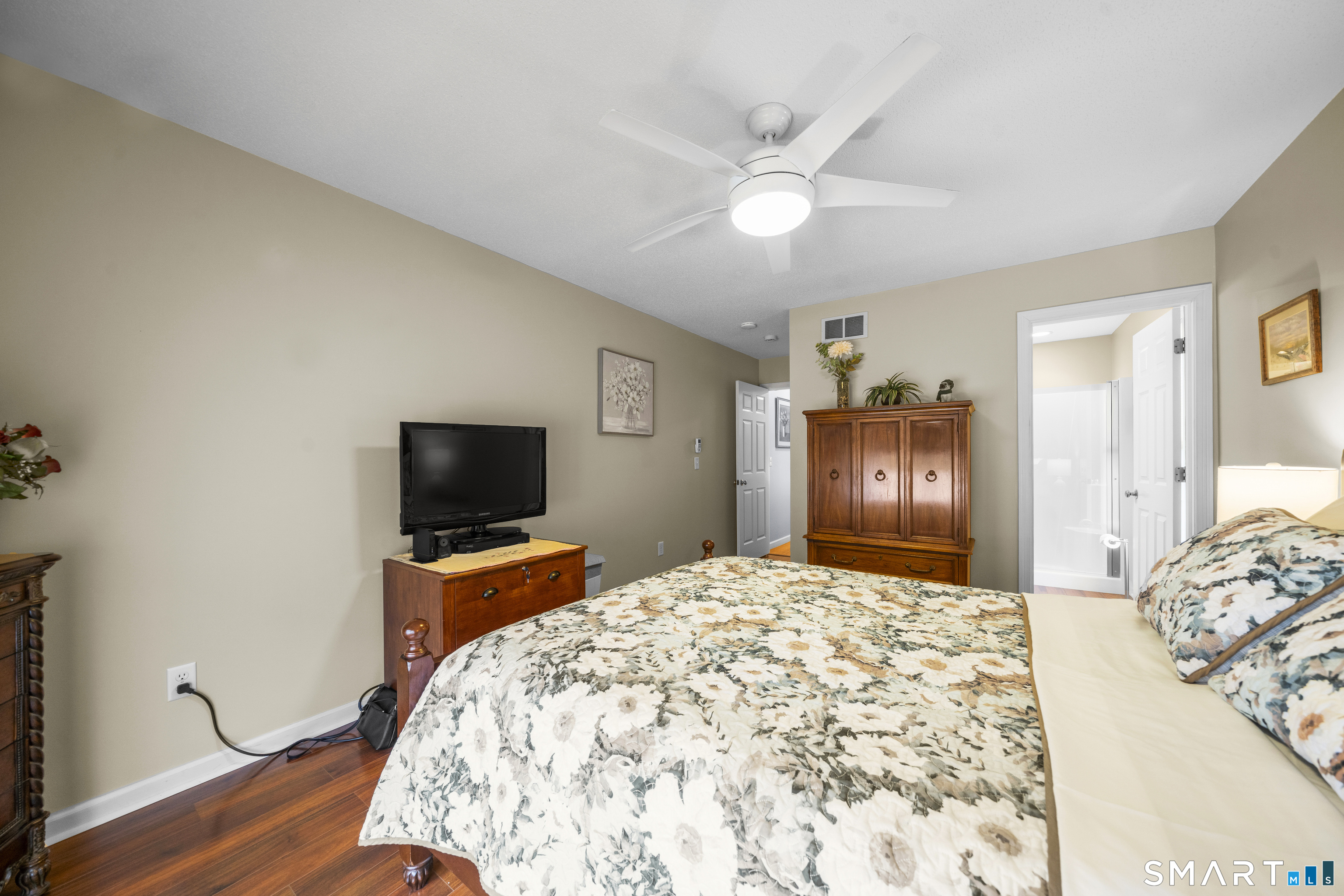 7 Heather Lane, Unit 7 Suffield, CT 06078 - Photo 18 of 34 a bedroom with a bed and a flat screen tv