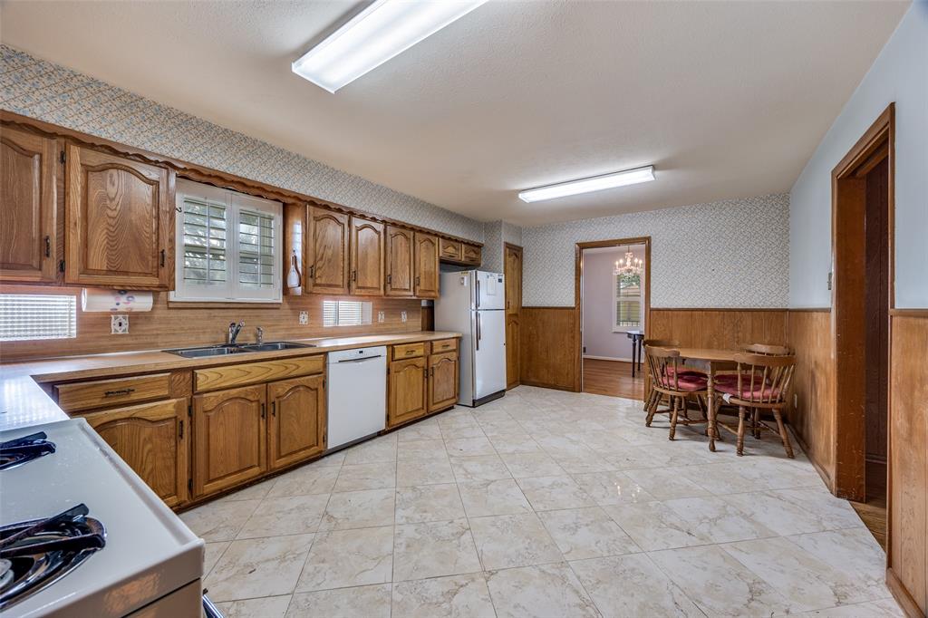 3019 Sharpview Lane Dallas, TX 75228 - Photo 11 of 26 a kitchen with stainless steel appliances granite countertop a stove top oven a sink dishwasher and cabinets with wooden floor