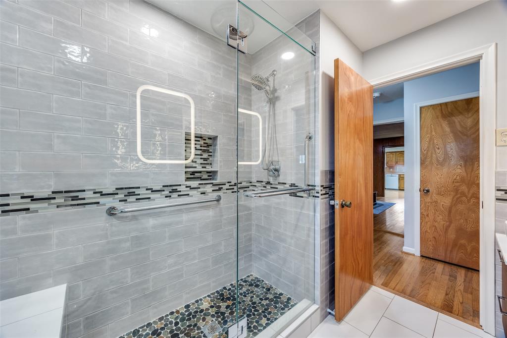 3019 Sharpview Lane Dallas, TX 75228 - Photo 5 of 26 a bathroom with a granite countertop sink a mirror and a shower