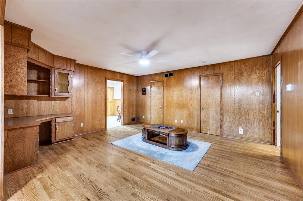 3019 Sharpview Lane Dallas, TX 75228 - Photo 10 of 26 a hallway with a large window and wooden floor