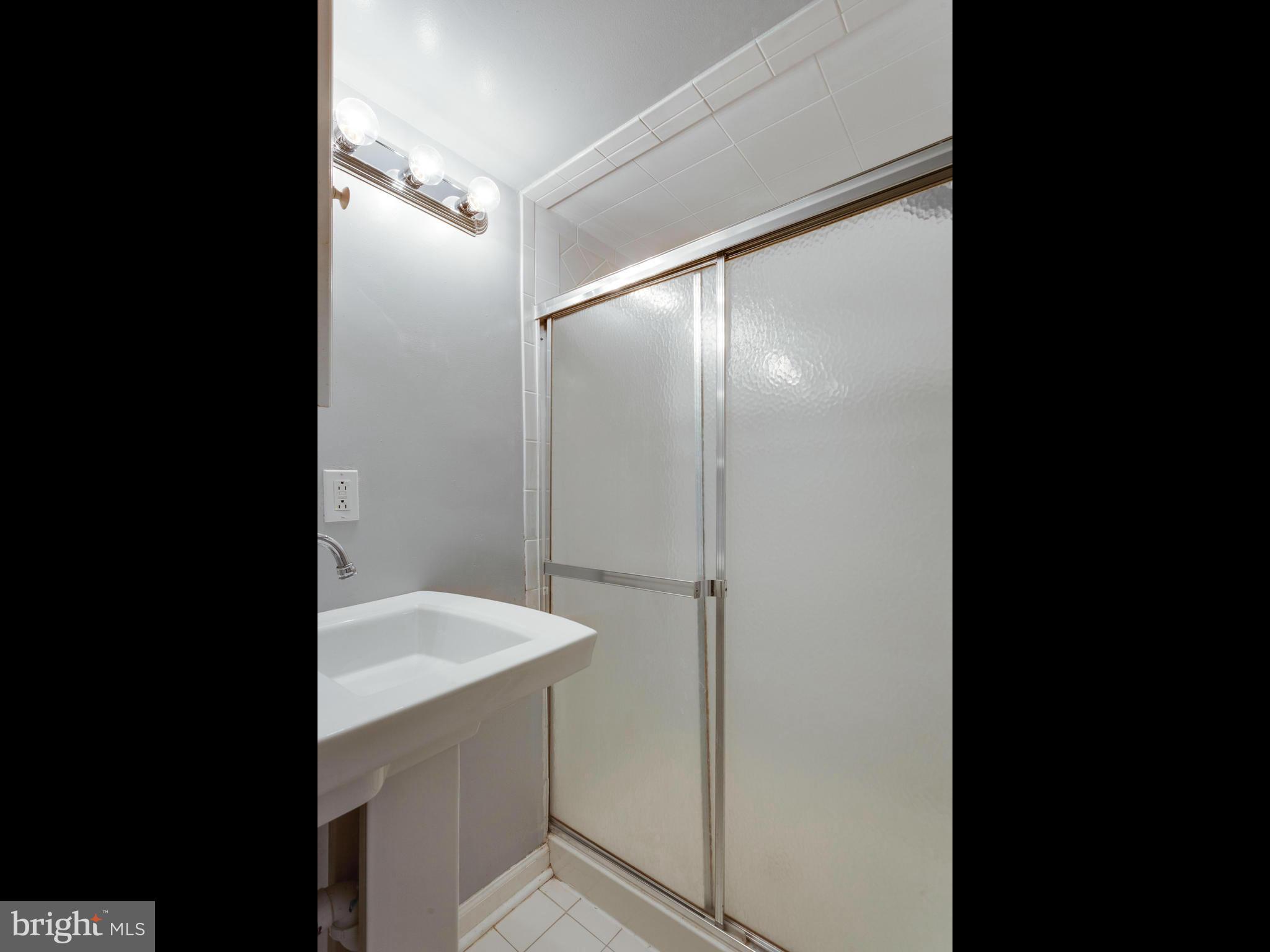 2334 Antiqua Court Reston, VA 20191 - Photo 19 of 30 a bathroom with a shower and a sink