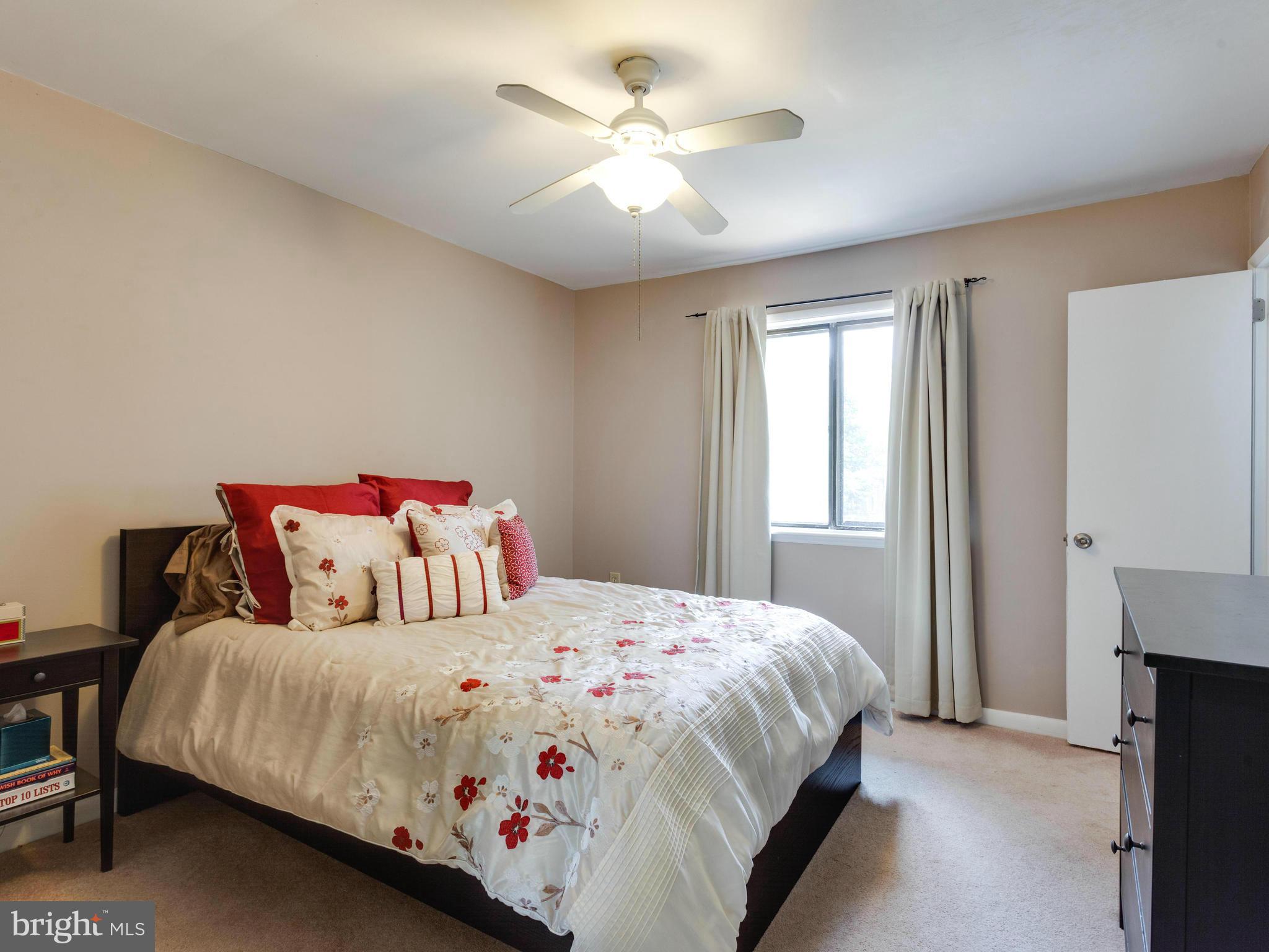 2334 Antiqua Court Reston, VA 20191 - Photo 20 of 30 a bedroom with a bed and a ceiling fan