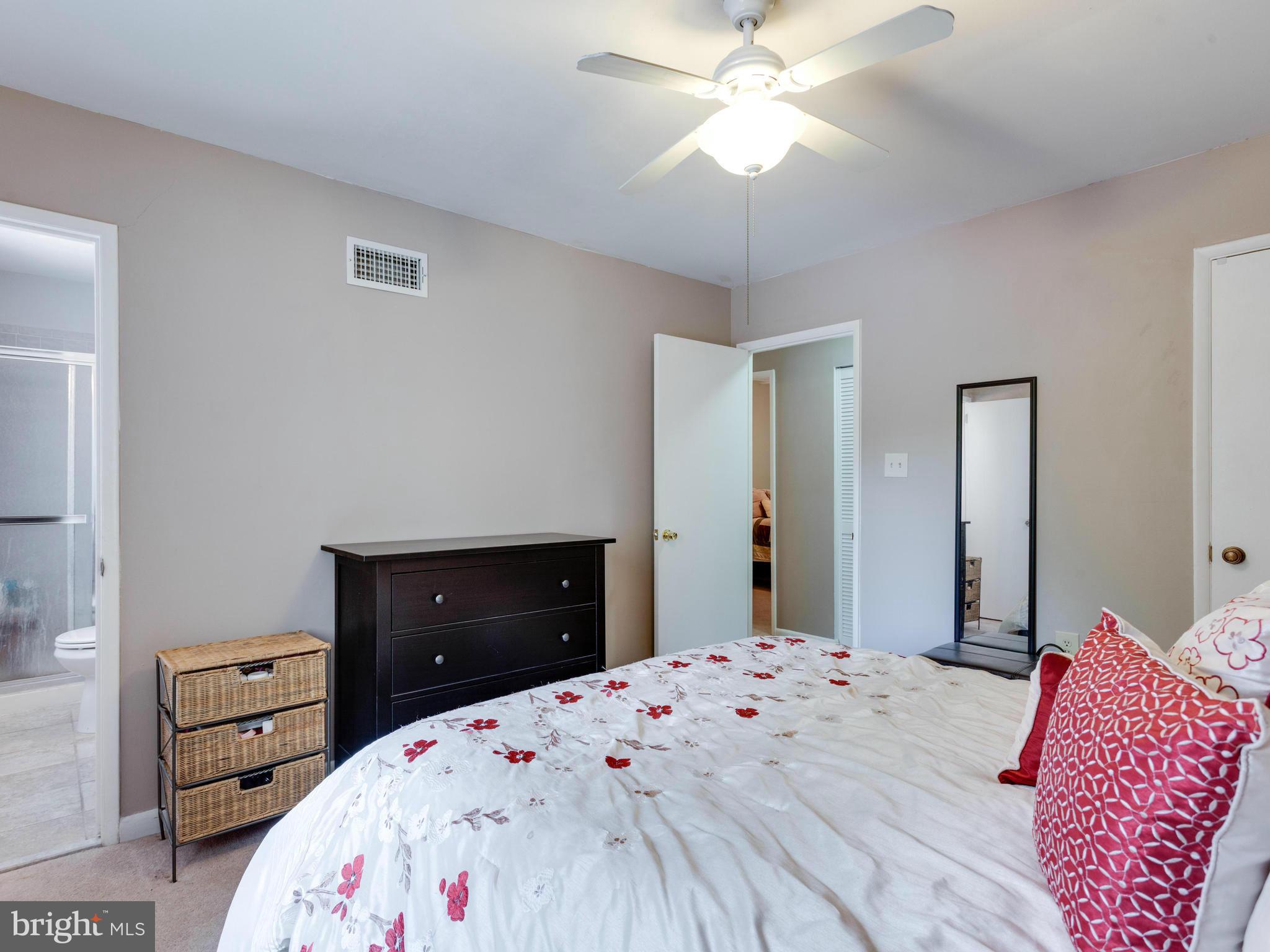 2334 Antiqua Court Reston, VA 20191 - Photo 21 of 30 a bedroom with a bed and a dresser
