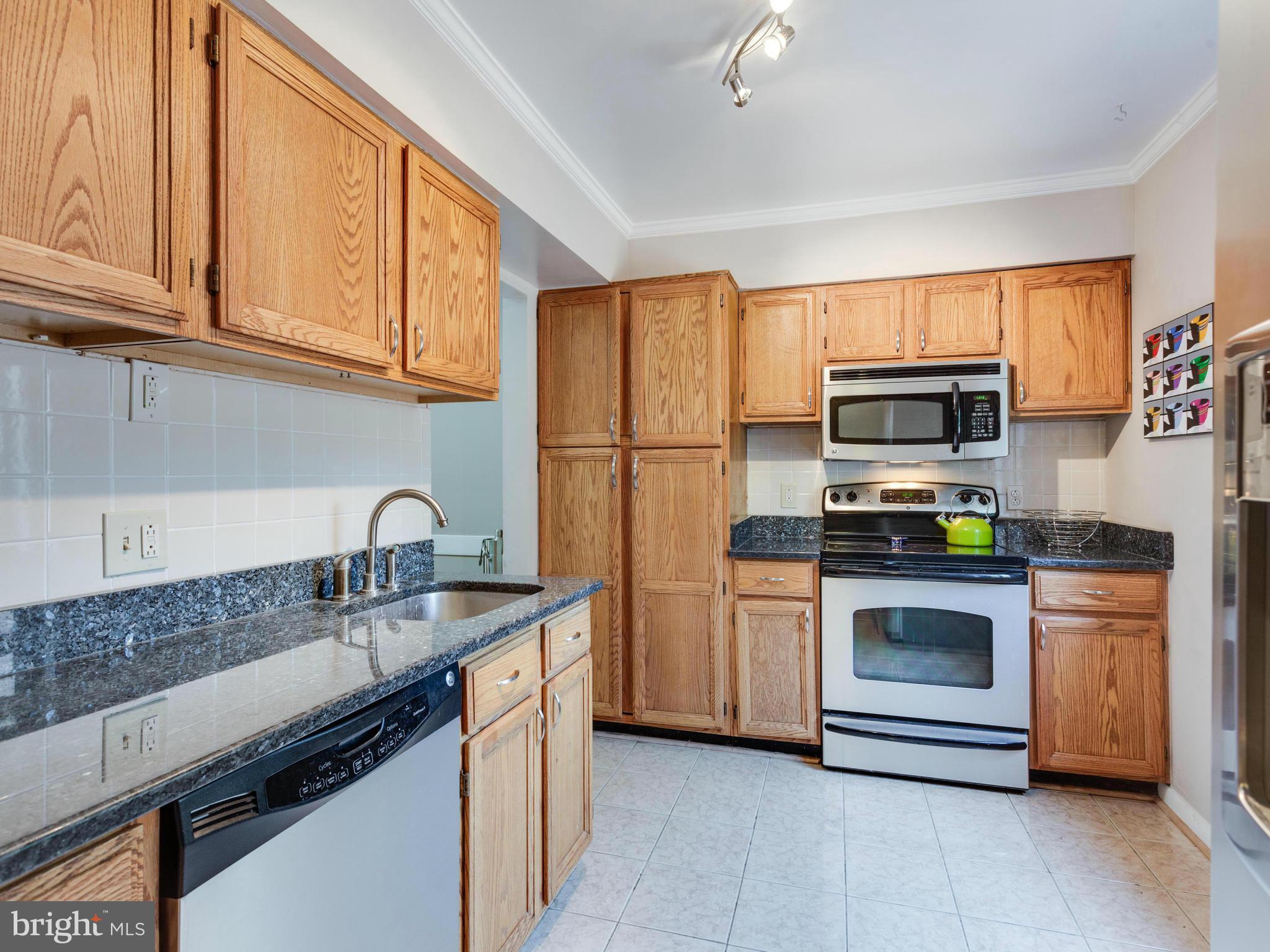2334 Antiqua Court Reston, VA 20191 - Photo 8 of 30 a kitchen with stainless steel appliances granite countertop a refrigerator stove and sink
