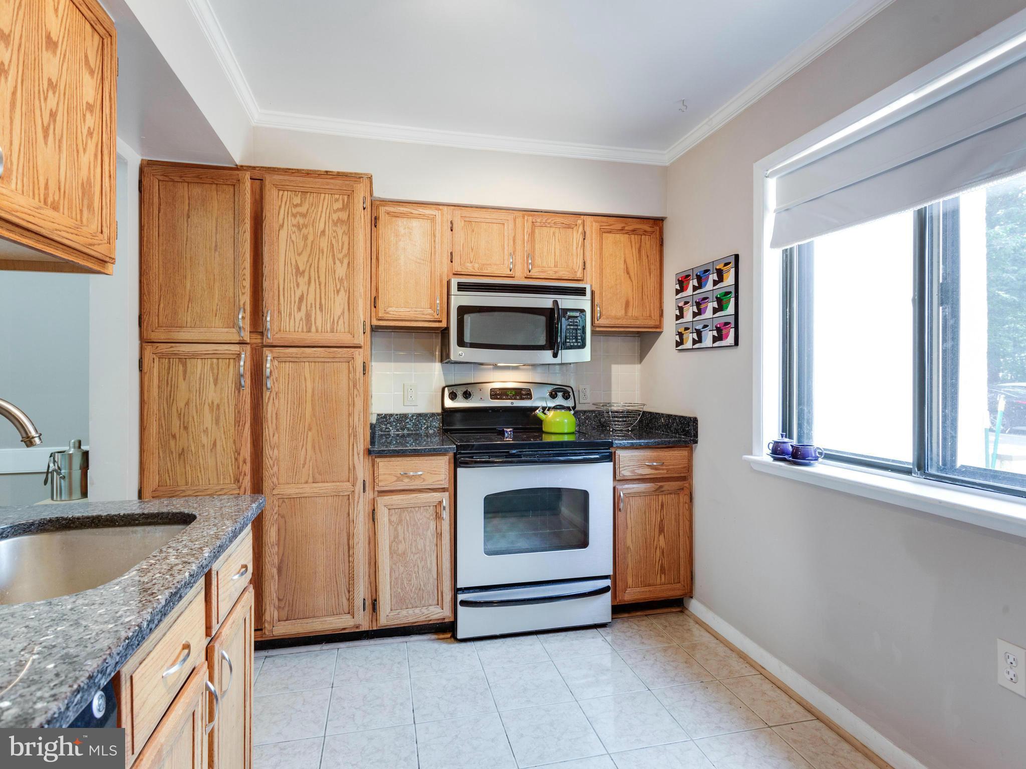 2334 Antiqua Court Reston, VA 20191 - Photo 9 of 30 a kitchen with granite countertop a sink stove and refrigerator