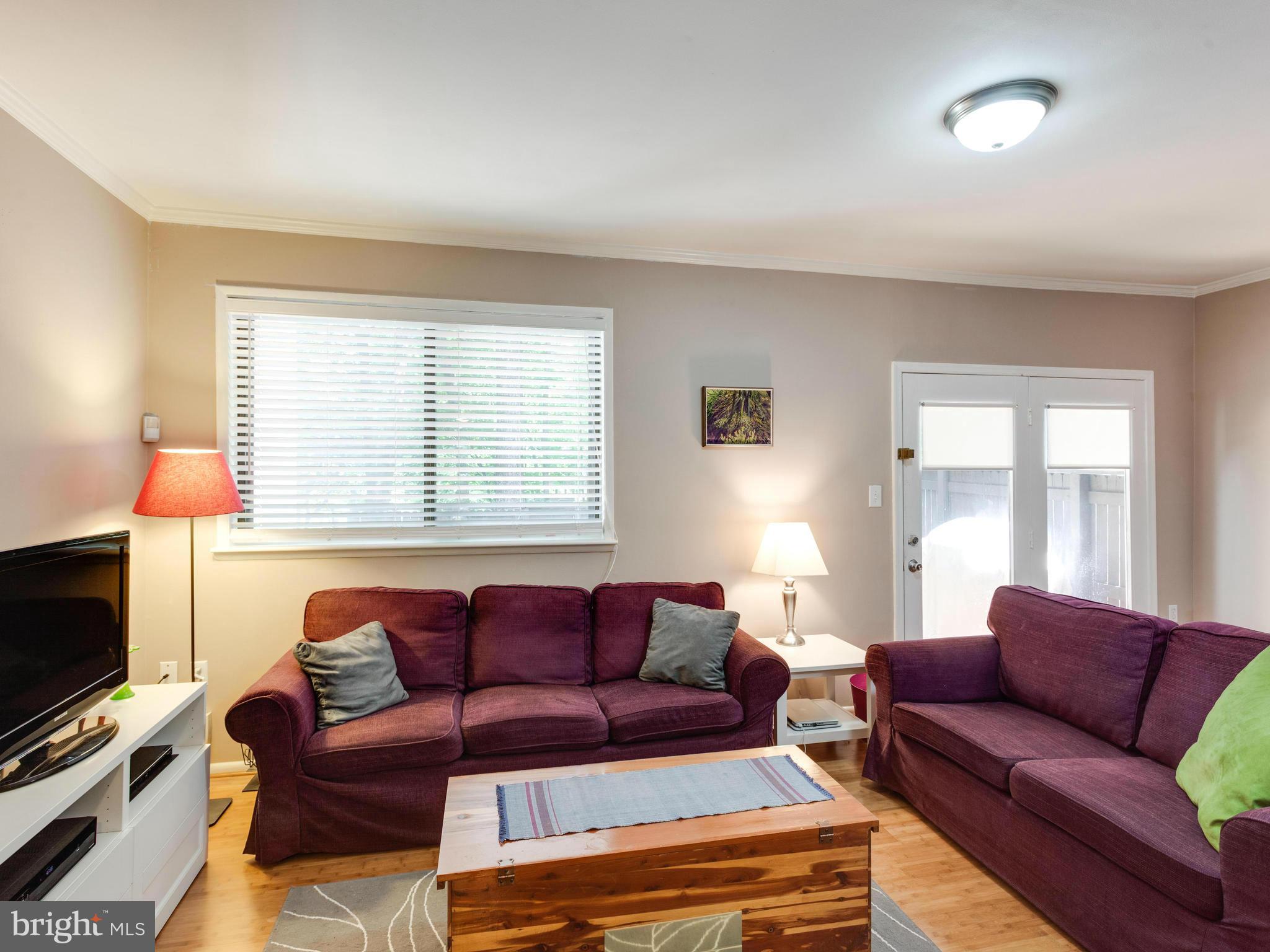 2334 Antiqua Court Reston, VA 20191 - Photo 10 of 30 a living room with furniture a flat screen tv and a window