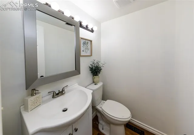 a bathroom with a sink toilet and mirror