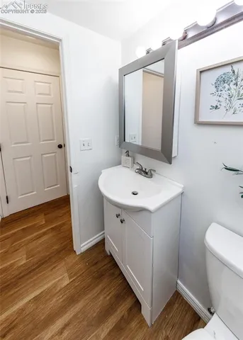 a bathroom with a sink mirror vanity and toilet