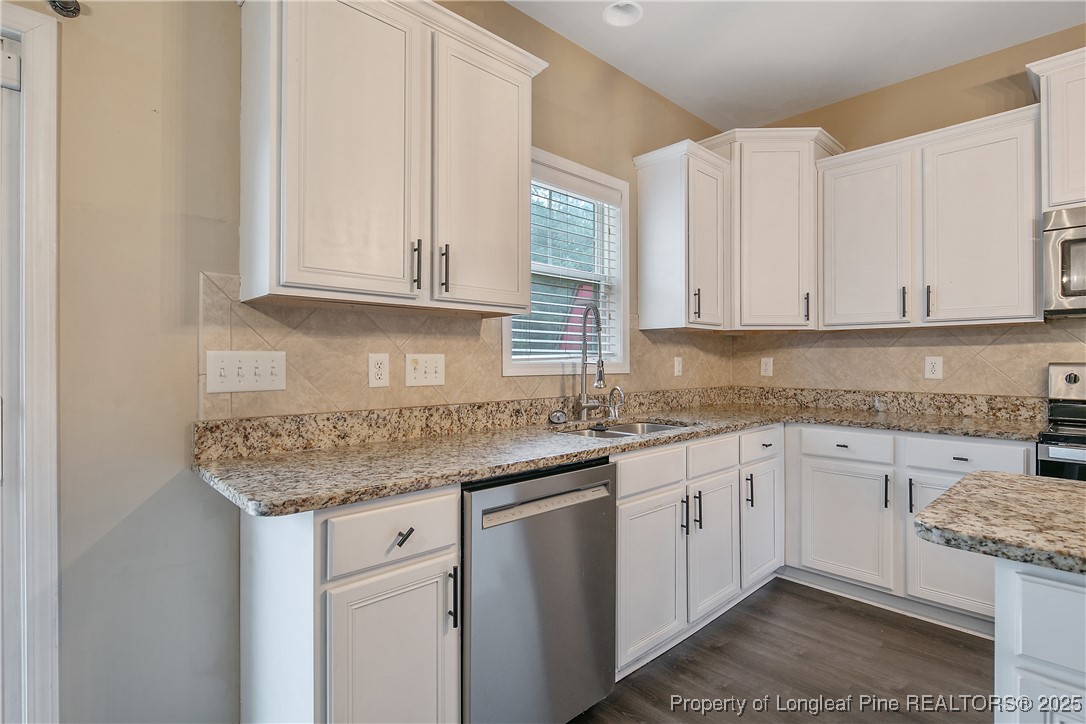 4964 Aberdeen Road Raeford, NC 28376 - Photo 16 of 50 a kitchen with granite countertop stainless steel appliances white cabinets granite counter tops and a sink