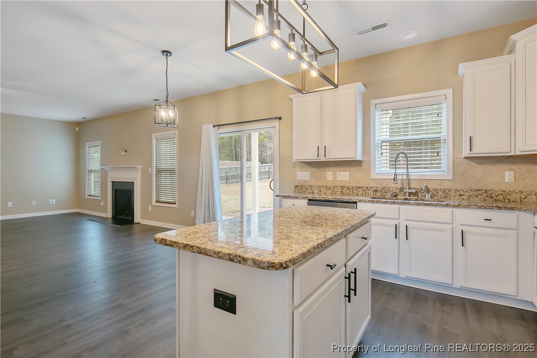 4964 Aberdeen Road Raeford, NC 28376 - Photo 19 of 50 a kitchen with sink cabinets and wooden floor
