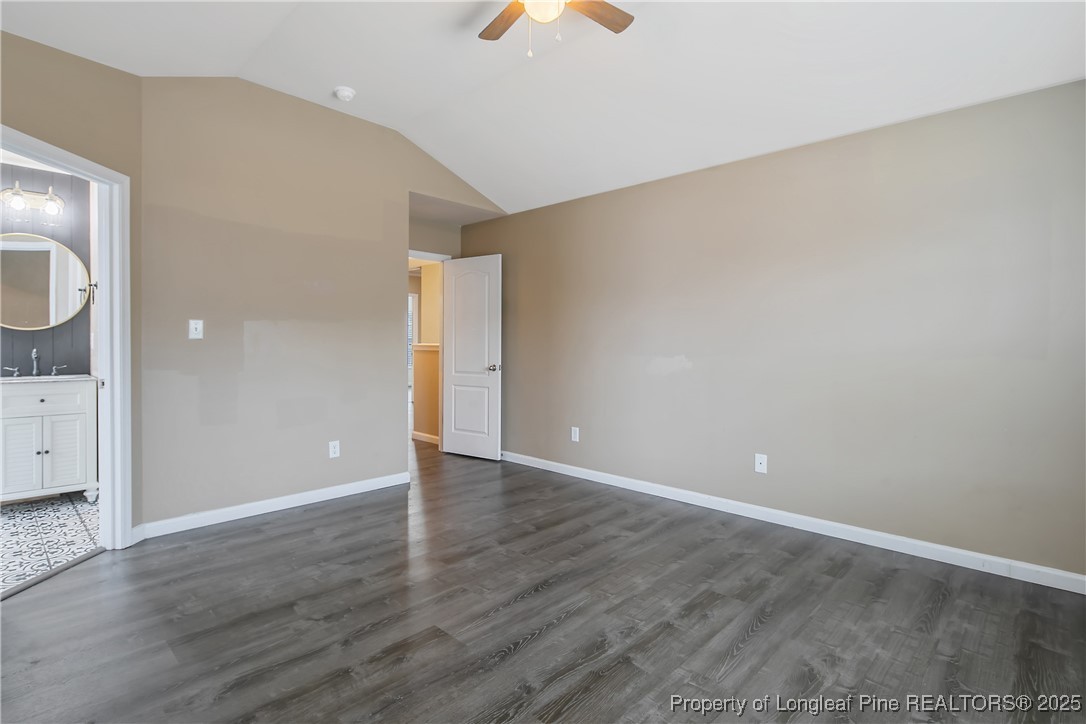 4964 Aberdeen Road Raeford, NC 28376 - Photo 24 of 50 a view of an empty room with wooden floor and a ceiling fan