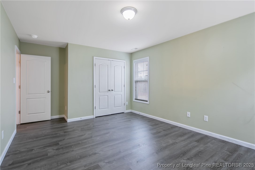 4964 Aberdeen Road Raeford, NC 28376 - Photo 34 of 50 a view of an empty room with wooden floor and closet