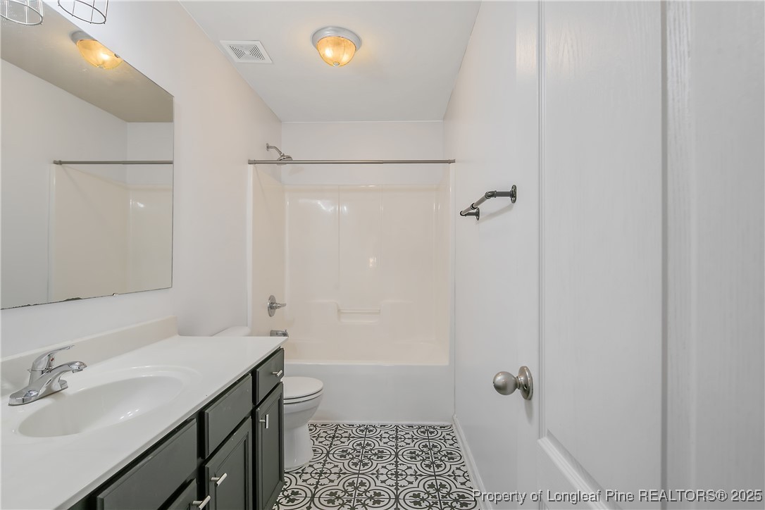 4964 Aberdeen Road Raeford, NC 28376 - Photo 40 of 50 a bathroom with a sink and shower