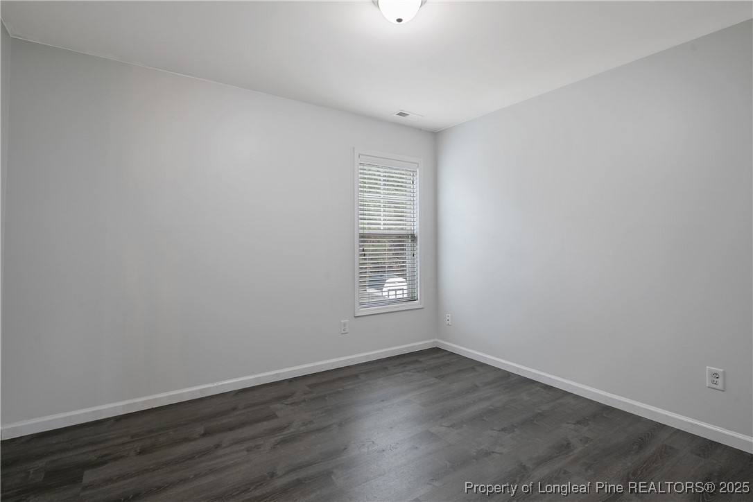 4964 Aberdeen Road Raeford, NC 28376 - Photo 42 of 50 a view of an empty room with wooden floor and a window