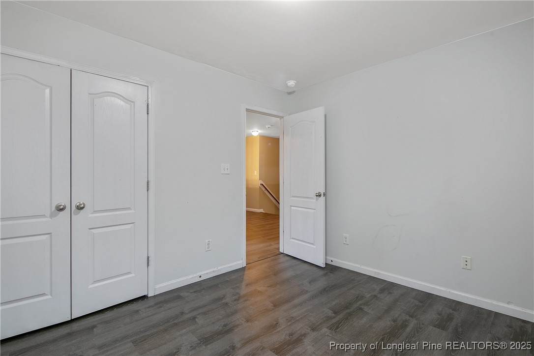 4964 Aberdeen Road Raeford, NC 28376 - Photo 44 of 50 a view of an empty room with wooden floor and closet