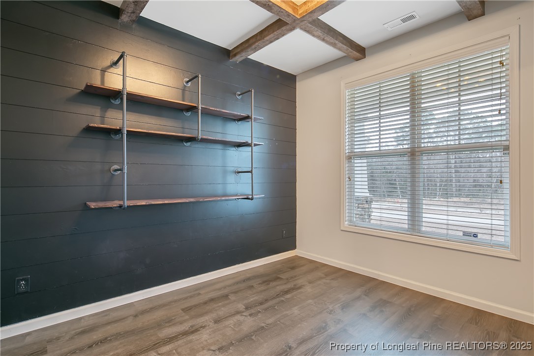 4964 Aberdeen Road Raeford, NC 28376 - Photo 7 of 50 an empty room with wooden floor and windows