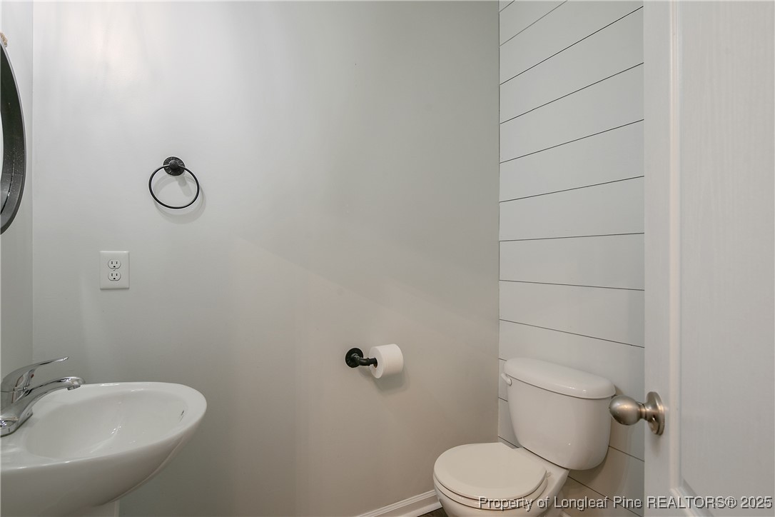 4964 Aberdeen Road Raeford, NC 28376 - Photo 9 of 50 a bathroom with a toilet and a sink